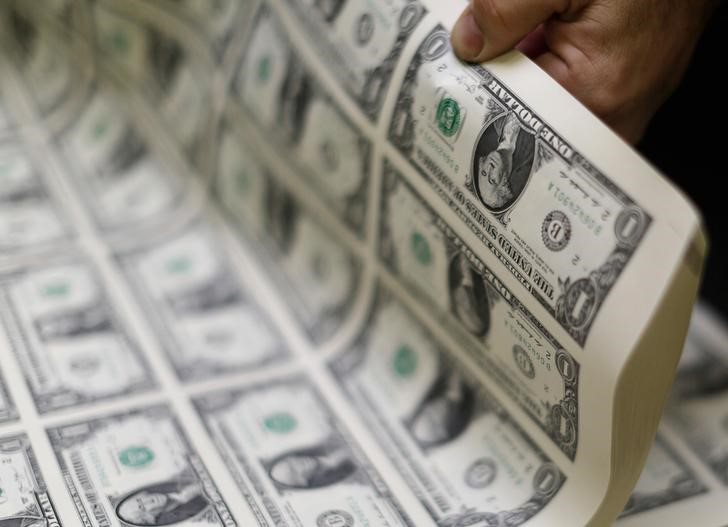 Dollar slips lower vs. rivals in quiet trade