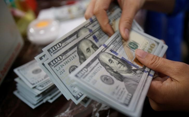 Dollar edges up, but on track for weekly loss