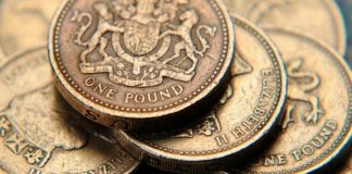 Sterling trades close to three-week low vs. surging dollar
