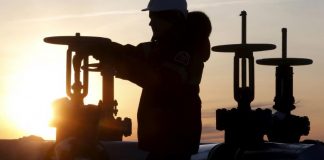 Oil companies shoulder pain of downturn with lower output